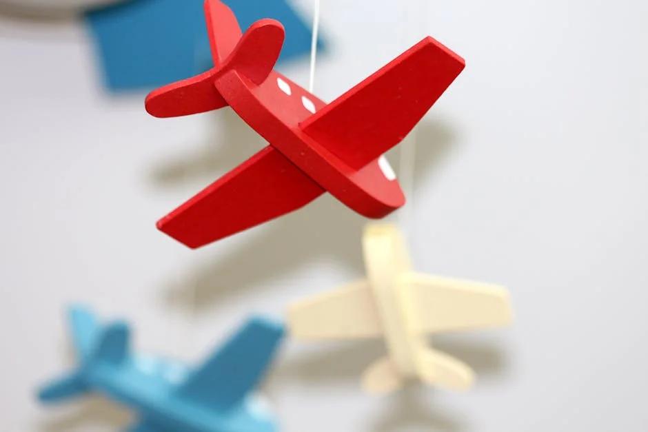 A close-up of colorful wooden airplane toys in a mobile, perfect for nursery décor.